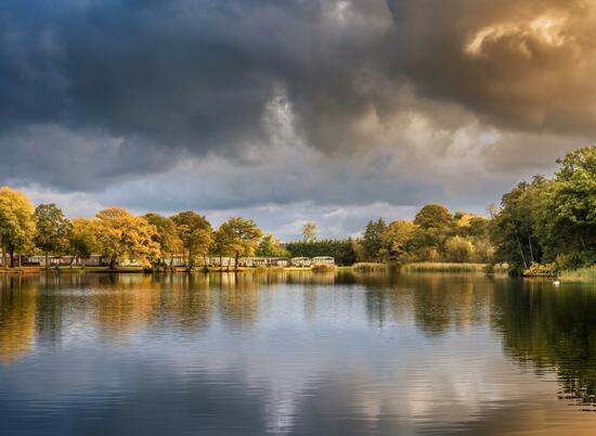 Autumn across the lake at Pearl Lake Country Holiday Park