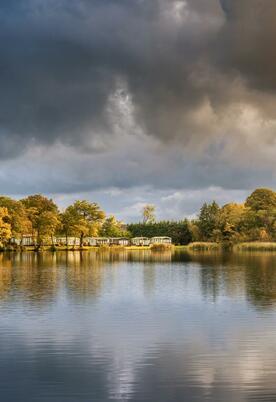 Autumn across the lake at Pearl Lake Country Holiday Park