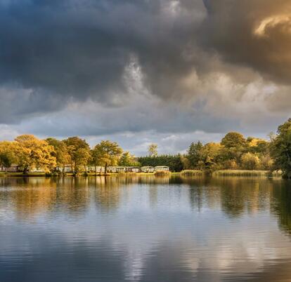 Autumn across the lake at Pearl Lake Country Holiday Park