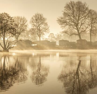 Sunrise over the lake and the lakeside holiday homes at Pearl Lake Herefordshire