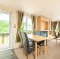 Regal Autograph holiday home for sale on 5 star caravan park with bar restaurant. Dining area photo