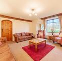 Self-actering holiday cottage with golf course - lounge photo